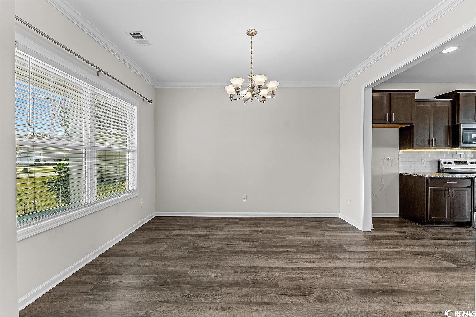 260 Red Maple Loop Longs, SC 29568 - Photo 26 of 34 Unfurnished dining area featuring crown molding, a