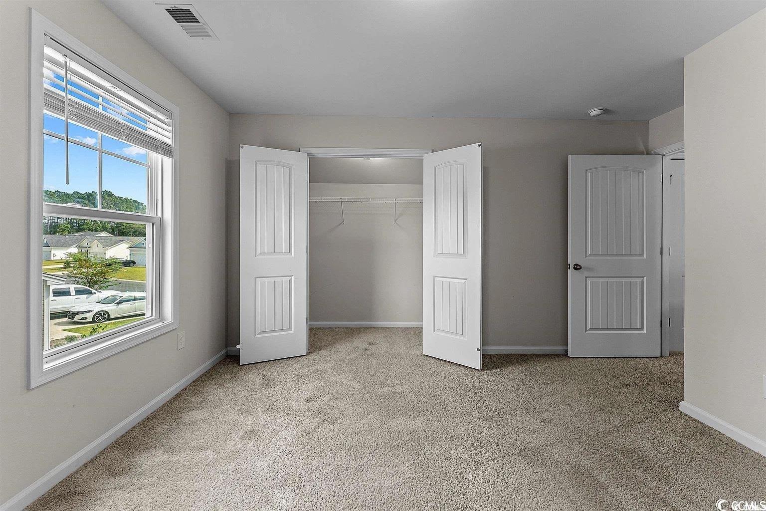 260 Red Maple Loop Longs, SC 29568 - Photo 10 of 34 bedroom with light carpet and a closet