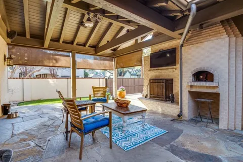 a living room with furniture a fireplace and a table