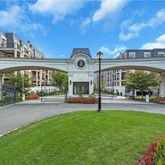 a view of a house with a big yard and large tree