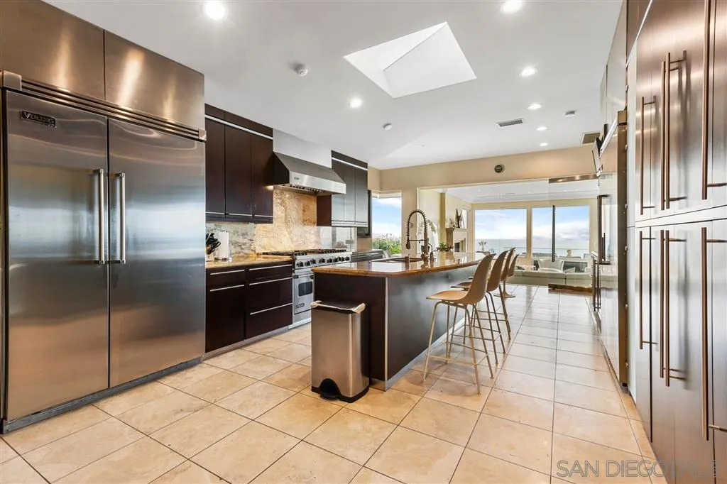 931 La Jolla Rancho Road La Jolla, CA 92037 - Photo 13 of 25 a kitchen with stainless steel appliances granite countertop a refrigerator a sink a stove and island