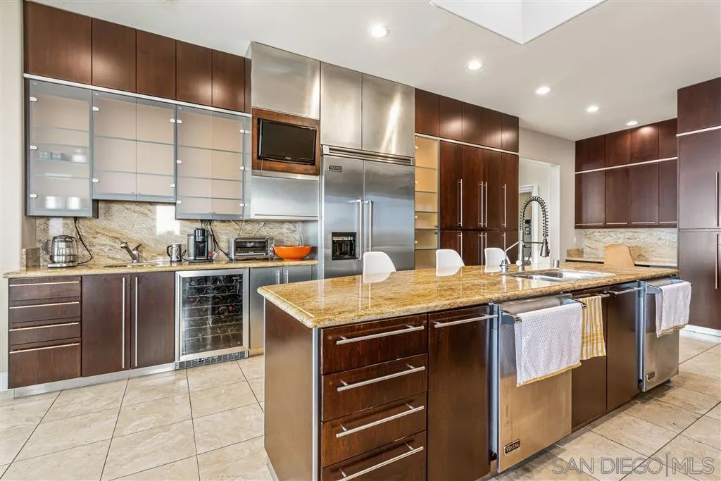 931 La Jolla Rancho Road La Jolla, CA 92037 - Photo 14 of 25 a kitchen with stainless steel appliances granite countertop a sink and a stove