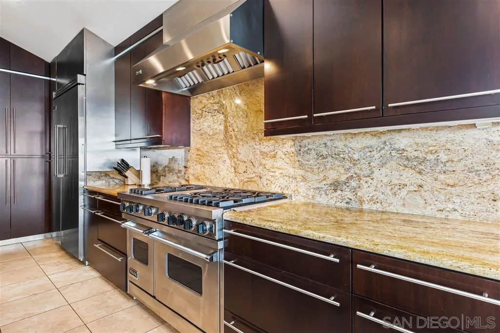 931 La Jolla Rancho Road La Jolla, CA 92037 - Photo 15 of 25 a kitchen with stainless steel appliances granite countertop a stove and a refrigerator