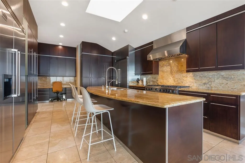 931 La Jolla Rancho Road La Jolla, CA 92037 - Photo 16 of 25 a kitchen with lots of counter space a sink and cabinets