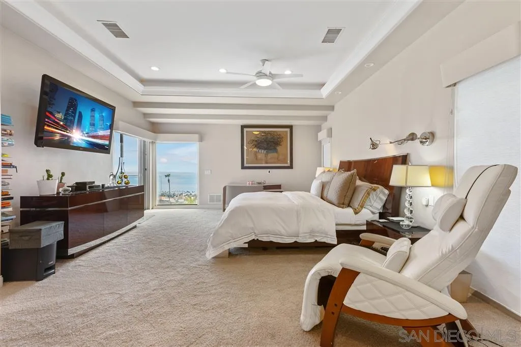 931 La Jolla Rancho Road La Jolla, CA 92037 - Photo 17 of 25 a spacious bedroom with a bed and couch