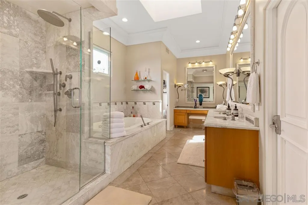 931 La Jolla Rancho Road La Jolla, CA 92037 - Photo 18 of 25 a bathroom with a tub shower and sink