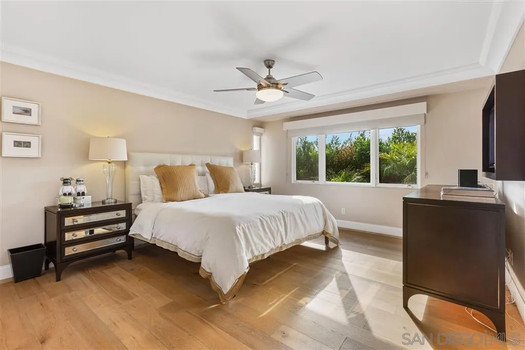931 La Jolla Rancho Road La Jolla, CA 92037 - Photo 20 of 25 a bedroom with a bed dresser and a large window