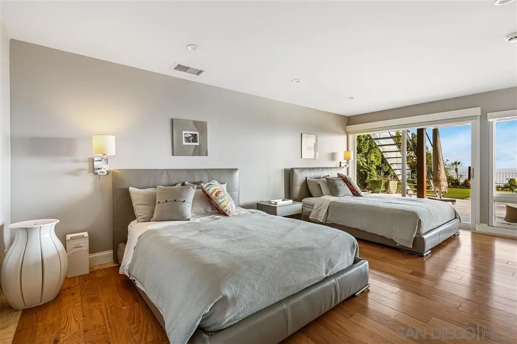 931 La Jolla Rancho Road La Jolla, CA 92037 - Photo 21 of 25 a bedroom with two beds and a large window
