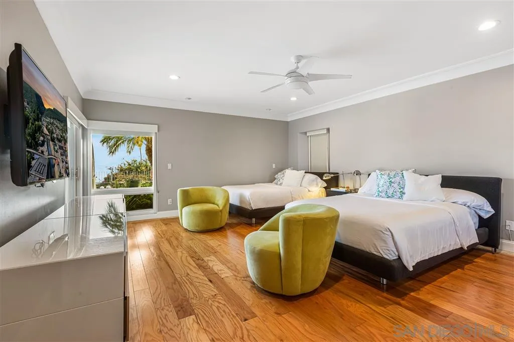 931 La Jolla Rancho Road La Jolla, CA 92037 - Photo 23 of 25 a spacious bedroom with a bed and a chandelier