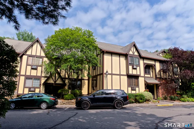 a couple of cars parked in front of a house