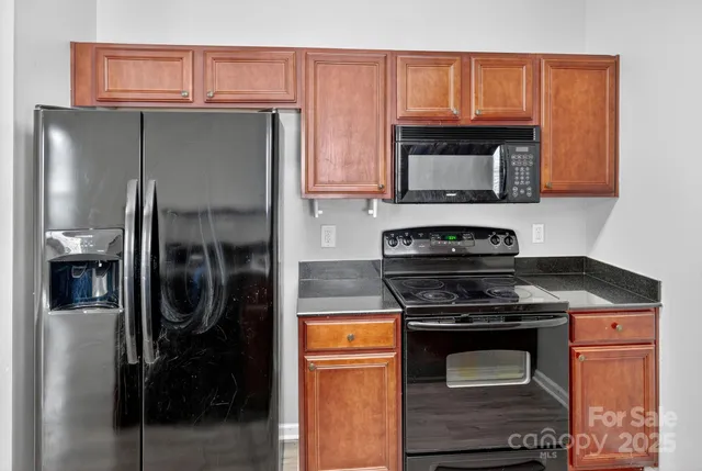 a view of a kitchen with wooden floor and a ceiling fan
