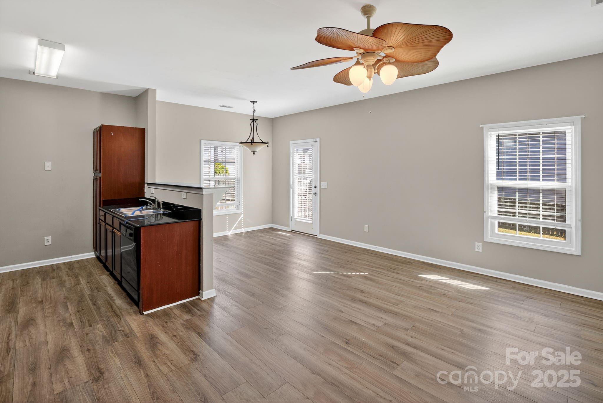 105 Whitton Court Lexington, SC 29073 - Photo 13 of 33 a view of a kitchen with wooden floor and a ceiling fan