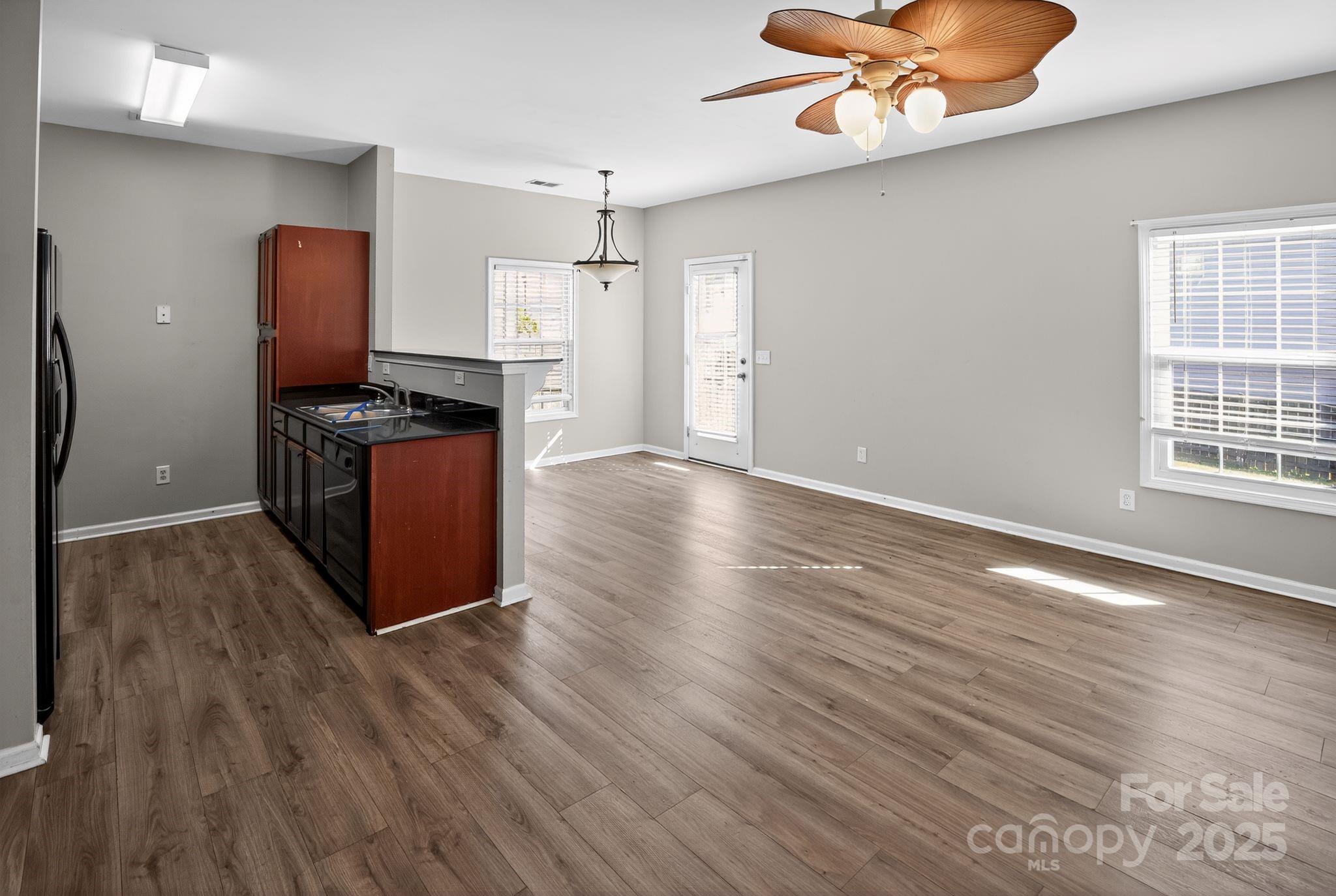 105 Whitton Court Lexington, SC 29073 - Photo 17 of 33 a kitchen with stainless steel appliances granite countertop a stove top oven a refrigerator with wooden floors and a large window