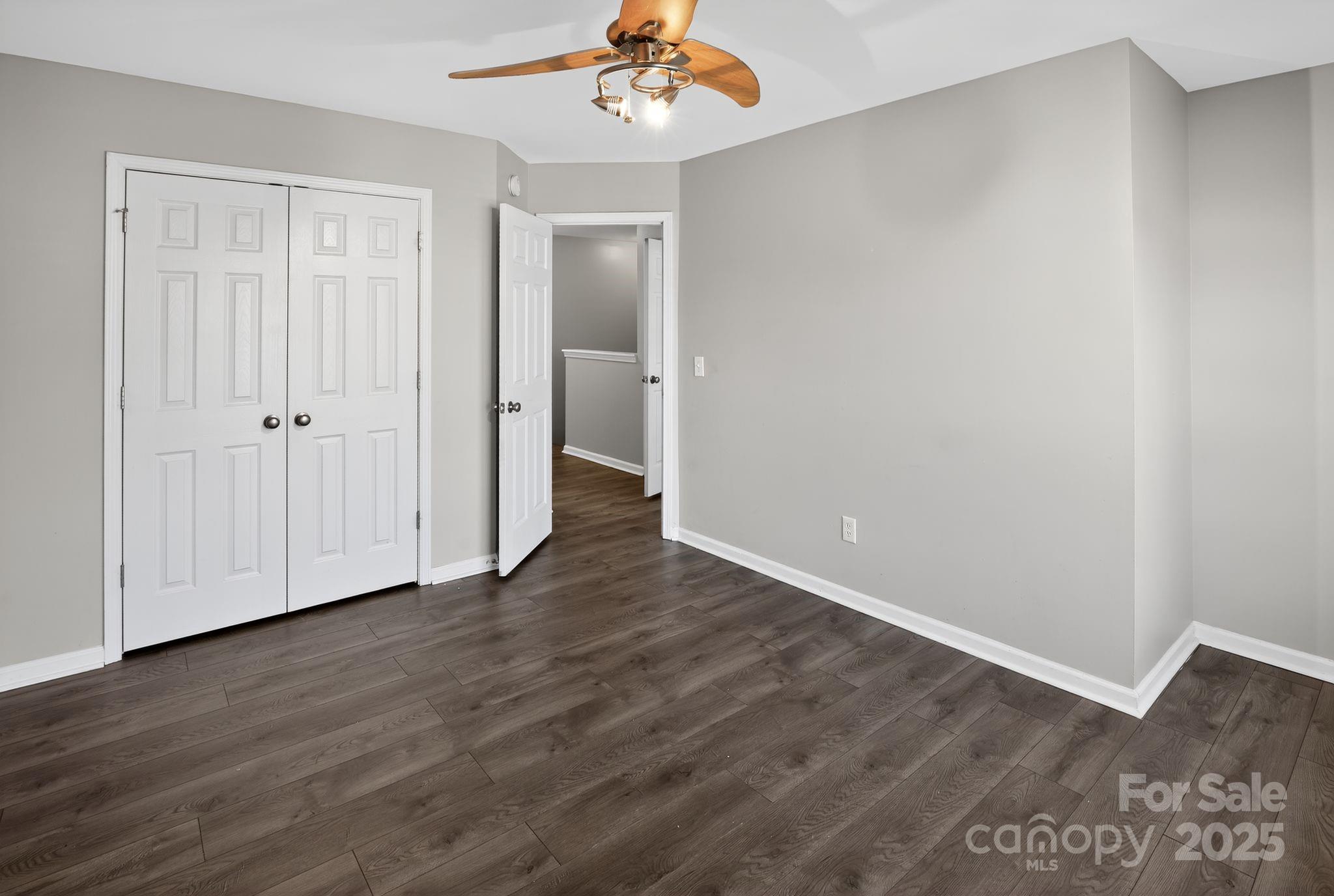105 Whitton Court Lexington, SC 29073 - Photo 21 of 33 a view of an empty room with wooden floor and a ceiling fan