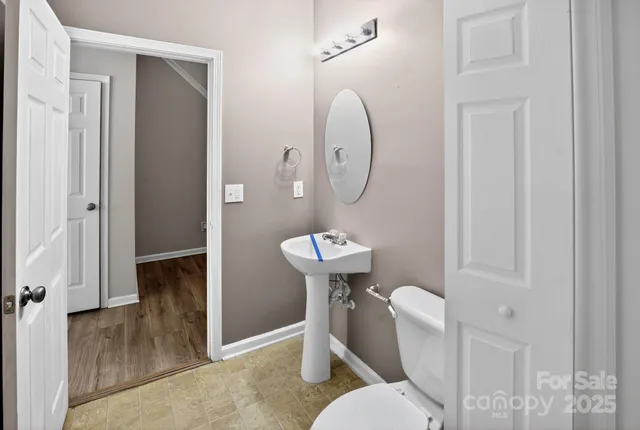 a white toilet sitting next to a bathroom sink
