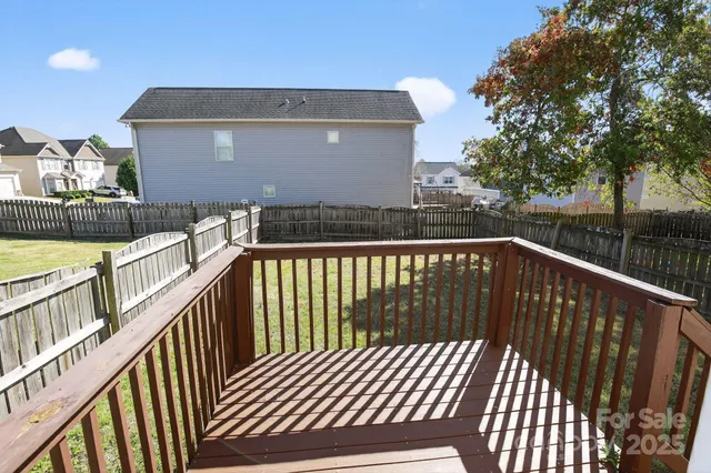 a view of balcony with wooden floor and fence