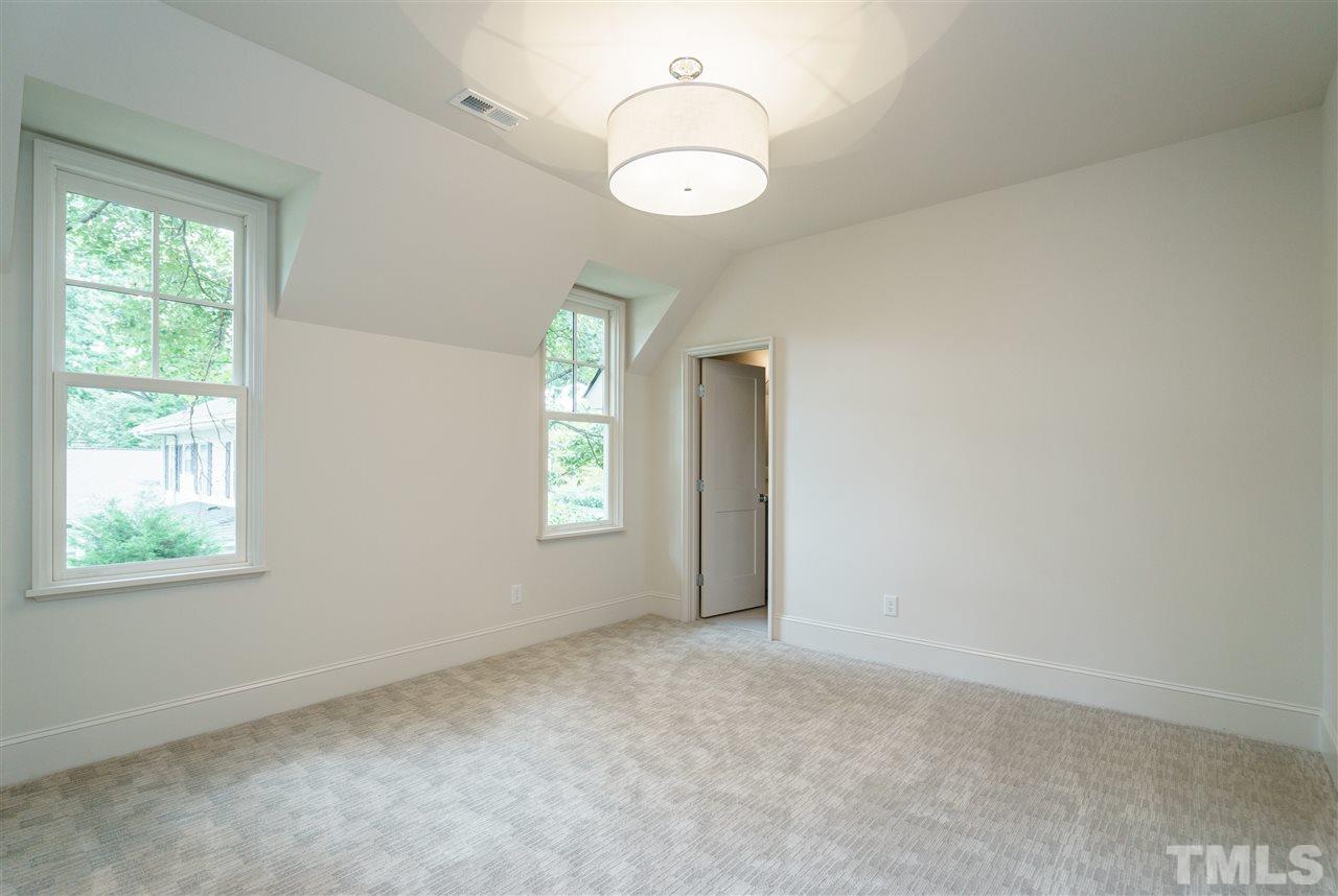 2129 Cowper Drive Raleigh, NC 27608 - Photo 23 of 25 an empty room with windows and mirror