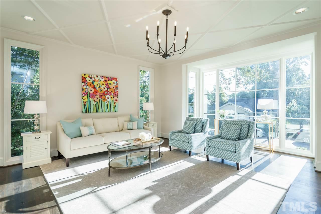2129 Cowper Drive Raleigh, NC 27608 - Photo 5 of 25 a living room with furniture a large window and a chandelier
