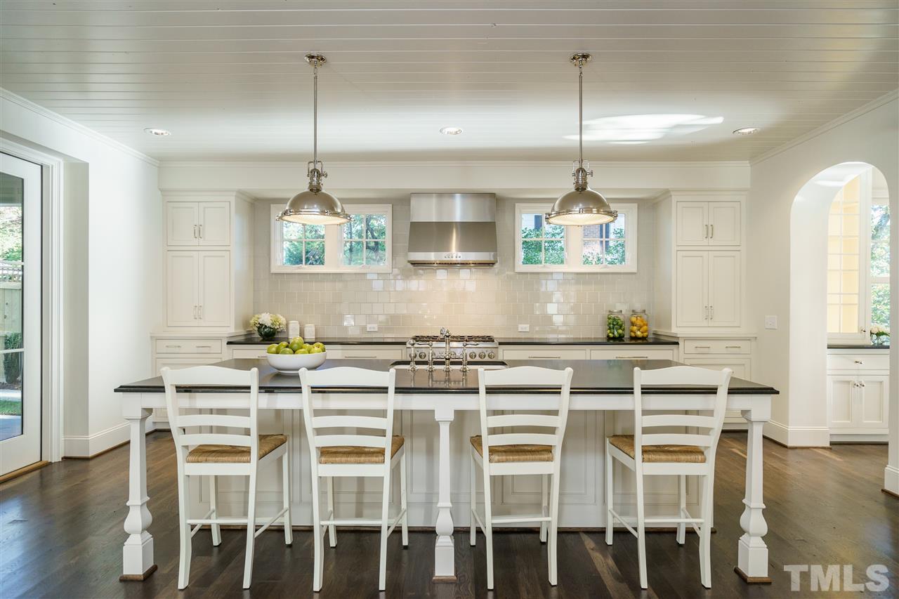 2129 Cowper Drive Raleigh, NC 27608 - Photo 9 of 25 a kitchen with a table and chairs in it