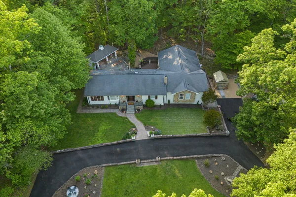 a front view of a house with swimming pool and porch