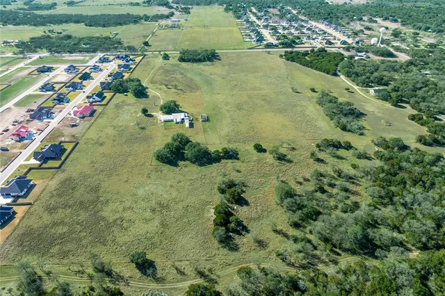 an aerial view of a residential houses with outdoor space