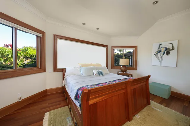 a bedroom with double bed and a window