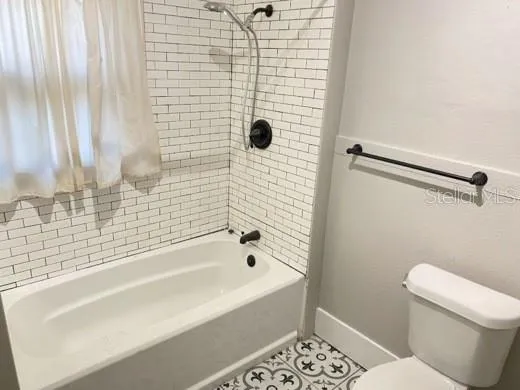a bathroom with a bathtub and a toilet