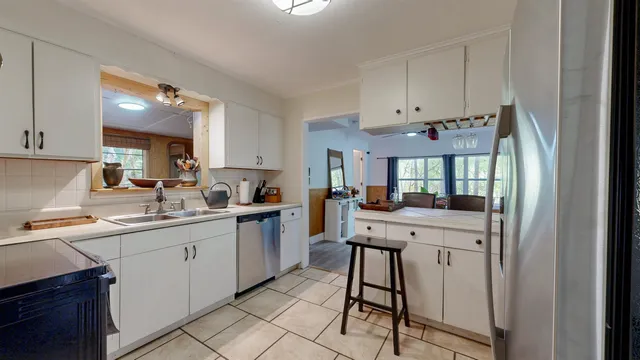 a kitchen with stainless steel appliances granite countertop a sink and cabinets