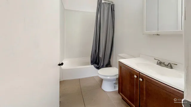 a bedroom with furniture a bed and a large window