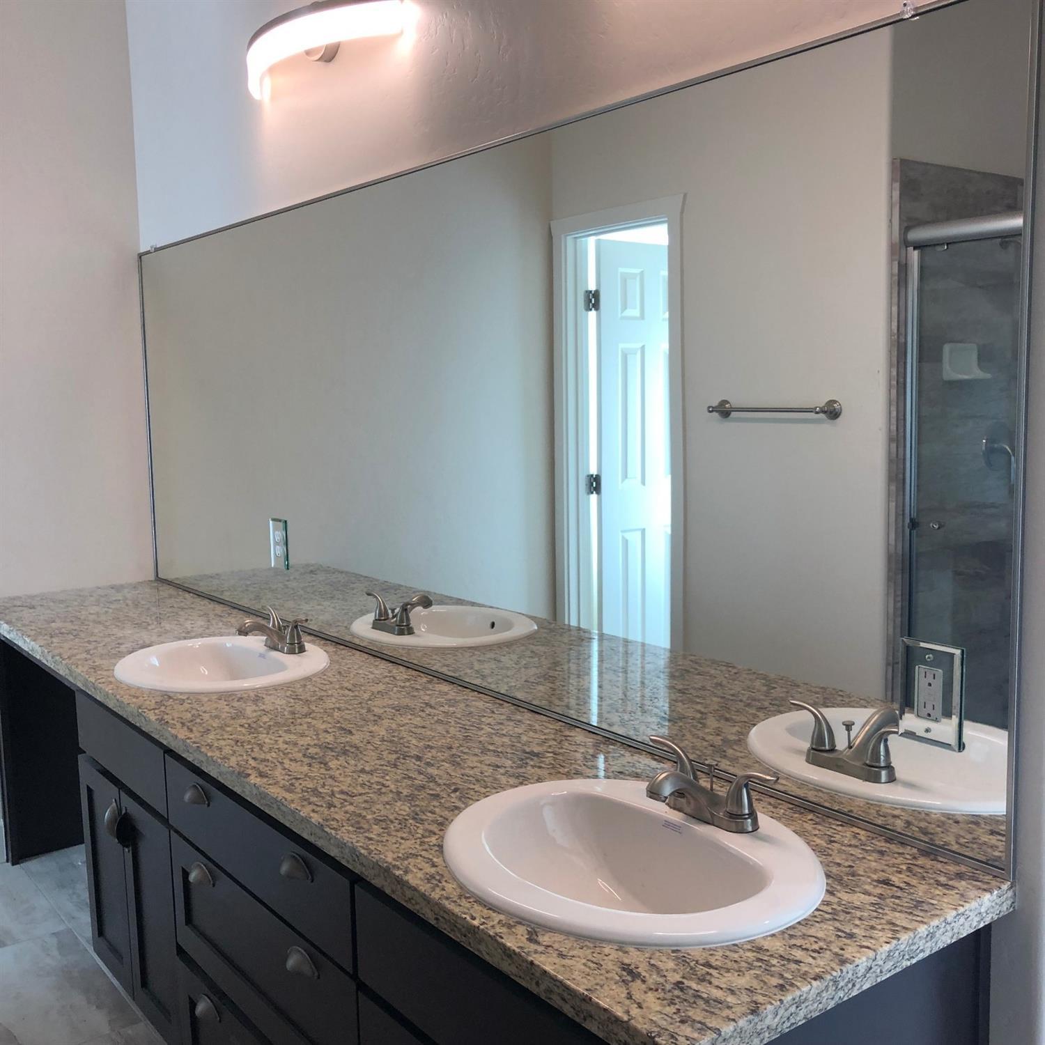 159 North Belmont Road Exeter, CA 93221 - Photo 24 of 28 a bathroom with a granite countertop sink and a mirror