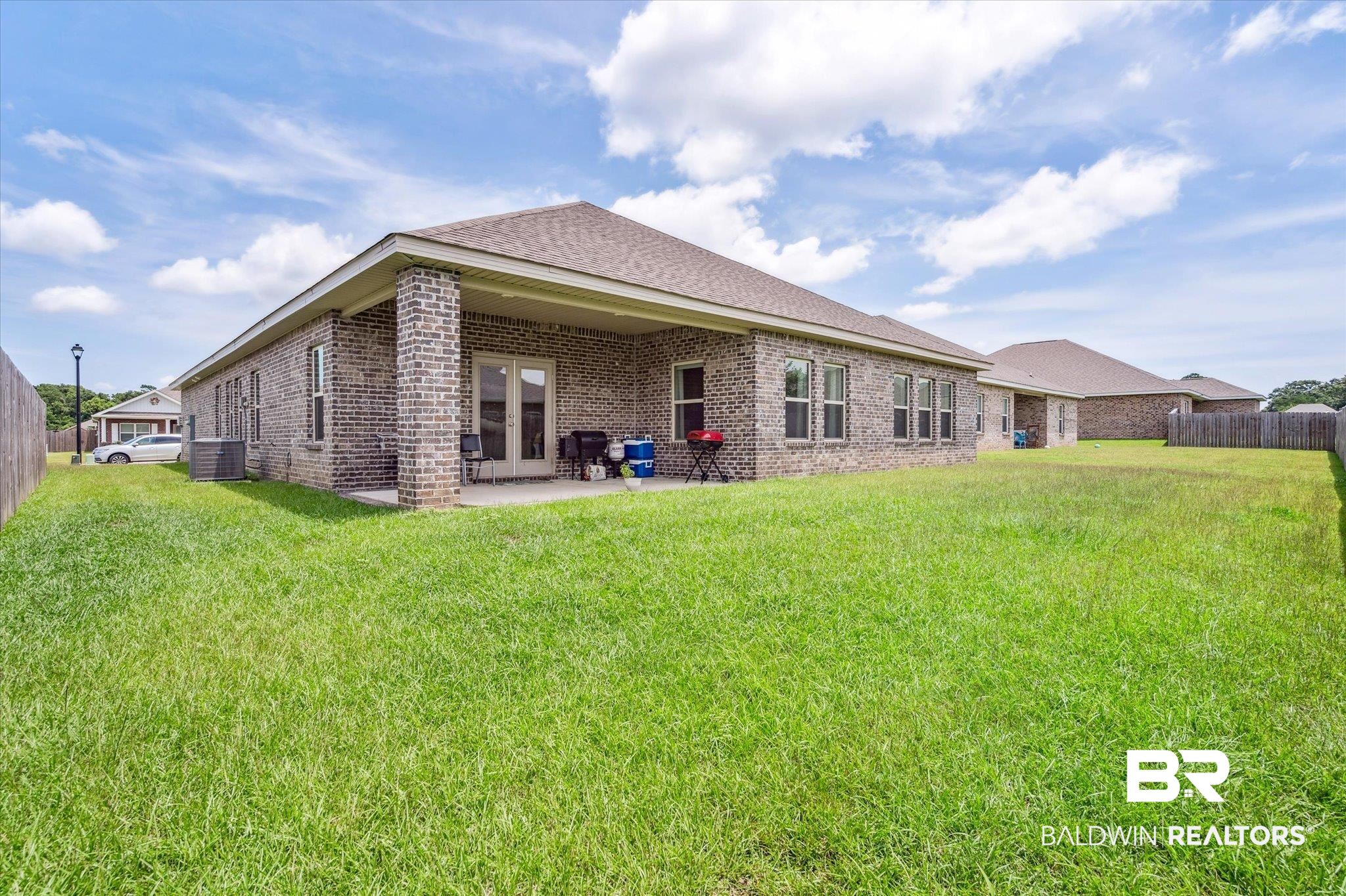 10501 Loamy Avenue Mobile, AL 36695 - Photo 27 of 30 Rear view of house featuring a patio, central AC, and a lawn