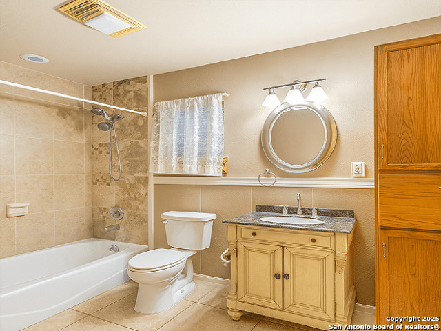 412 Moonlight Walk San Antonio, TX 78260 - Photo 12 of 26 a bathroom with a granite countertop toilet sink and bathtub