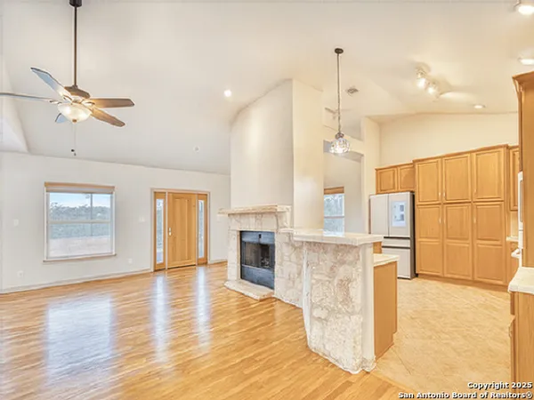 a view of a kitchen with furniture and a ceiling fan