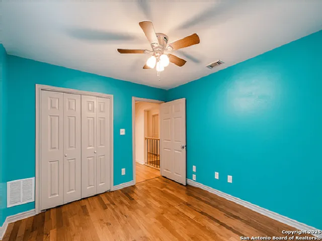 a view of an empty room with window and cabinet