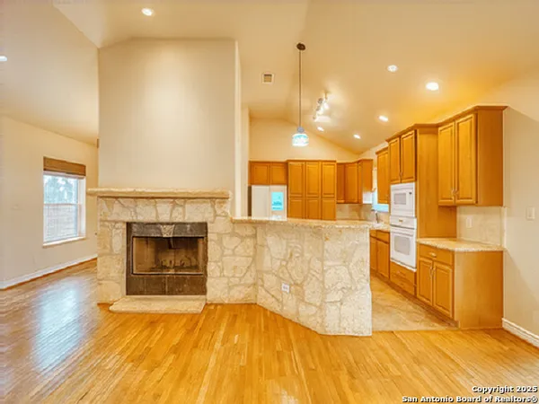 a view of kitchen with furniture and a fireplace