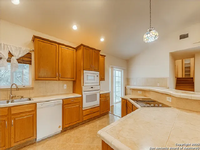 a kitchen with a stove a sink and a refrigerator