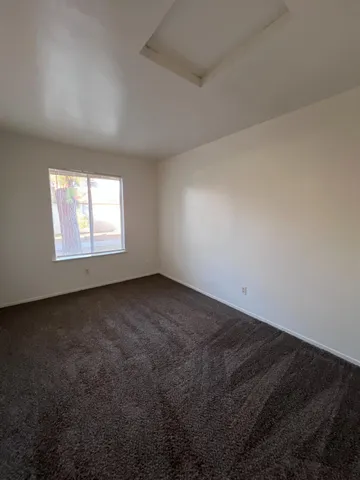 a view of an empty room and wooden floor