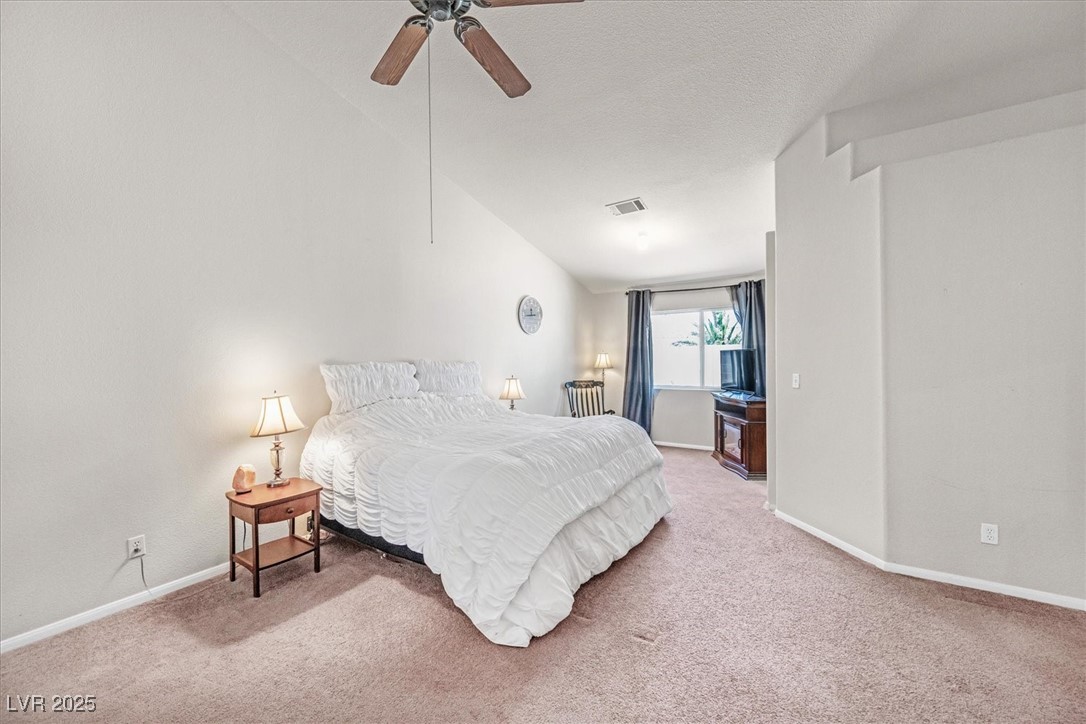 130 Park Ridge Lane Henderson, NV 89002 - Photo 18 of 69 Carpeted bedroom featuring baseboards, vaulted cei