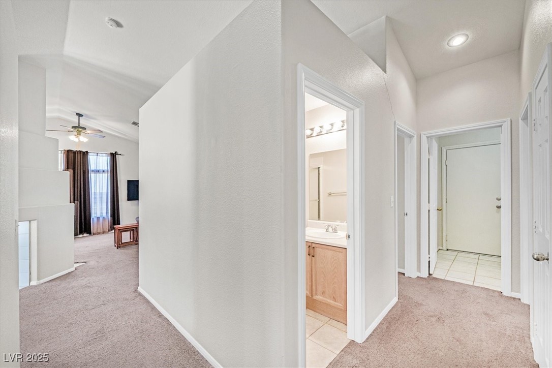 130 Park Ridge Lane Henderson, NV 89002 - Photo 24 of 69 Hallway with light carpet, a sink, light tile patt