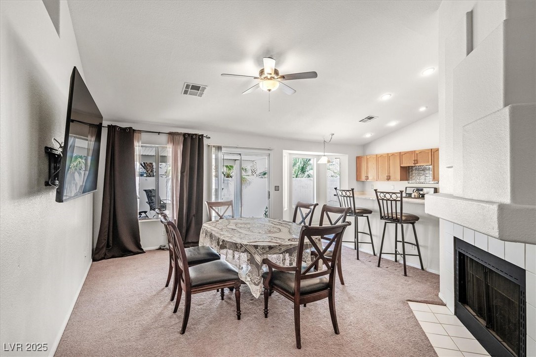 130 Park Ridge Lane Henderson, NV 89002 - Photo 9 of 69 Dining room with ceiling fan, light carpet, a fire