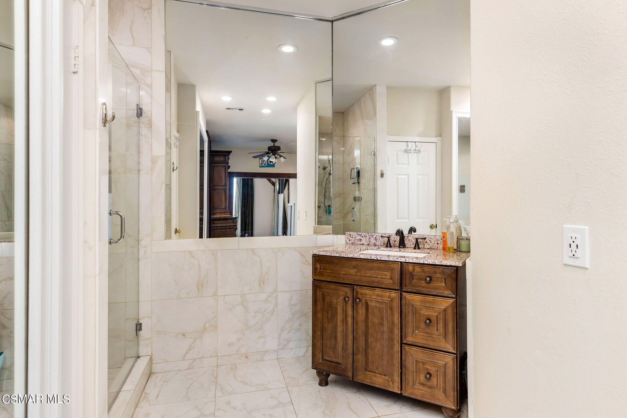15660 LaPeyre Road Moorpark, CA 93021 - Photo 15 of 84 a bathroom with a double vanity sink a mirror and a shower