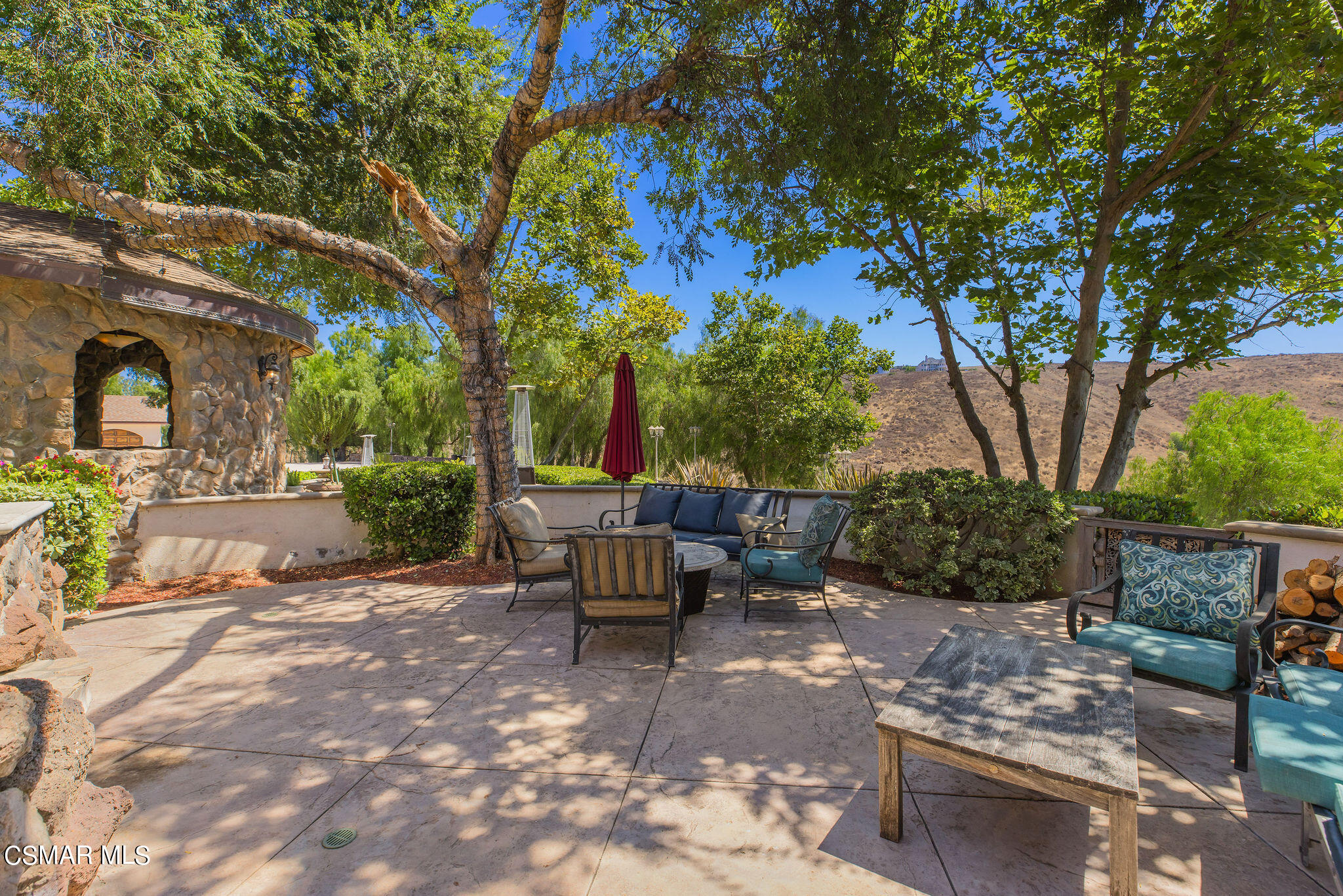 15660 LaPeyre Road Moorpark, CA 93021 - Photo 24 of 84 a view of a patio with table and chairs and potted plants