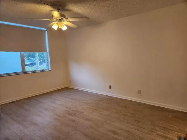 a view of a terrace with lawn chairs