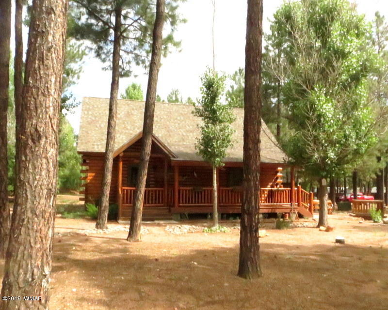 2312 Overgaard Springs Loop Overgaard, AZ 85933 - Photo 1 of 54 a front view of a building with trees