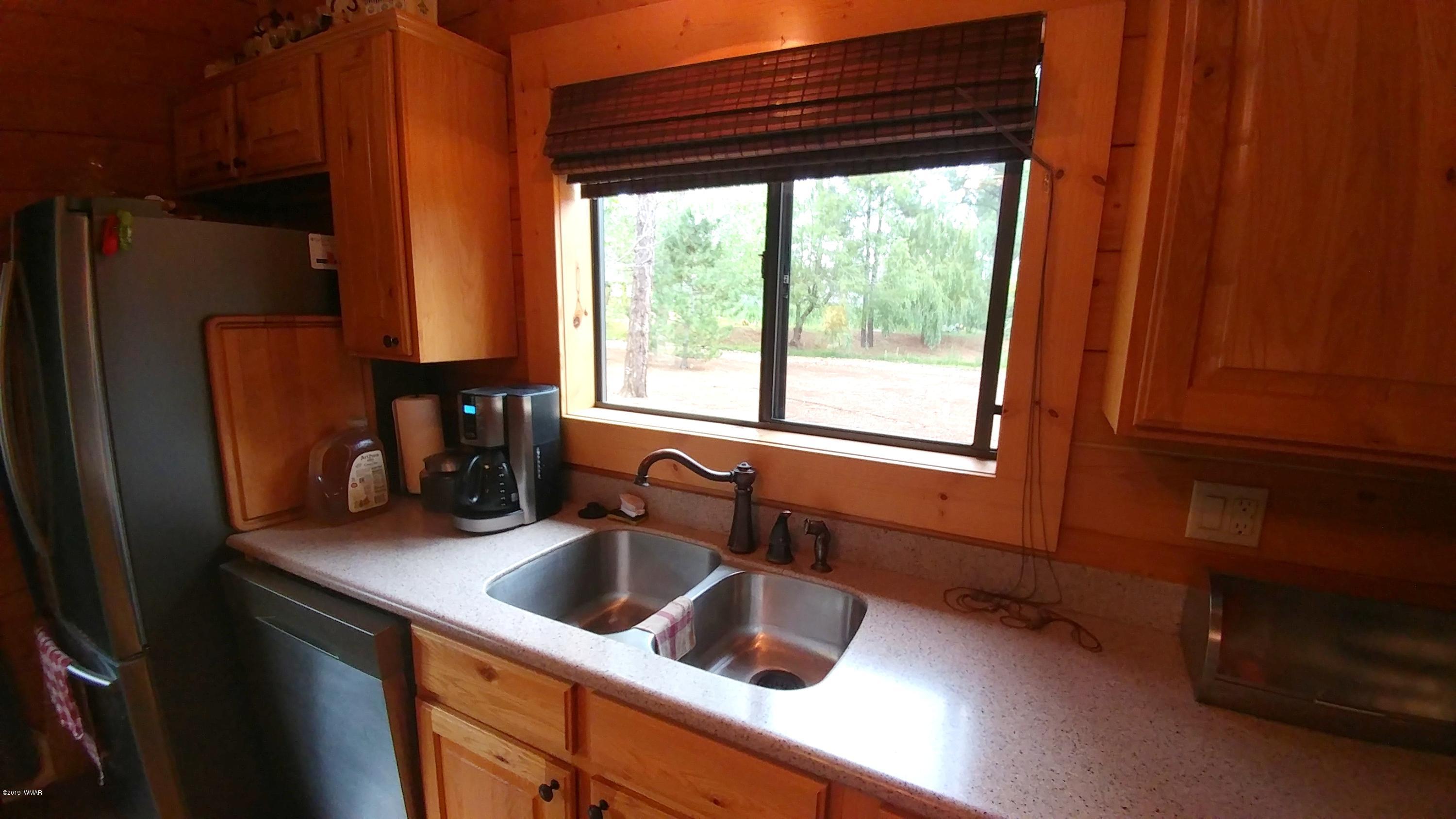 2312 Overgaard Springs Loop Overgaard, AZ 85933 - Photo 17 of 54 a kitchen with a sink a refrigerator and a window