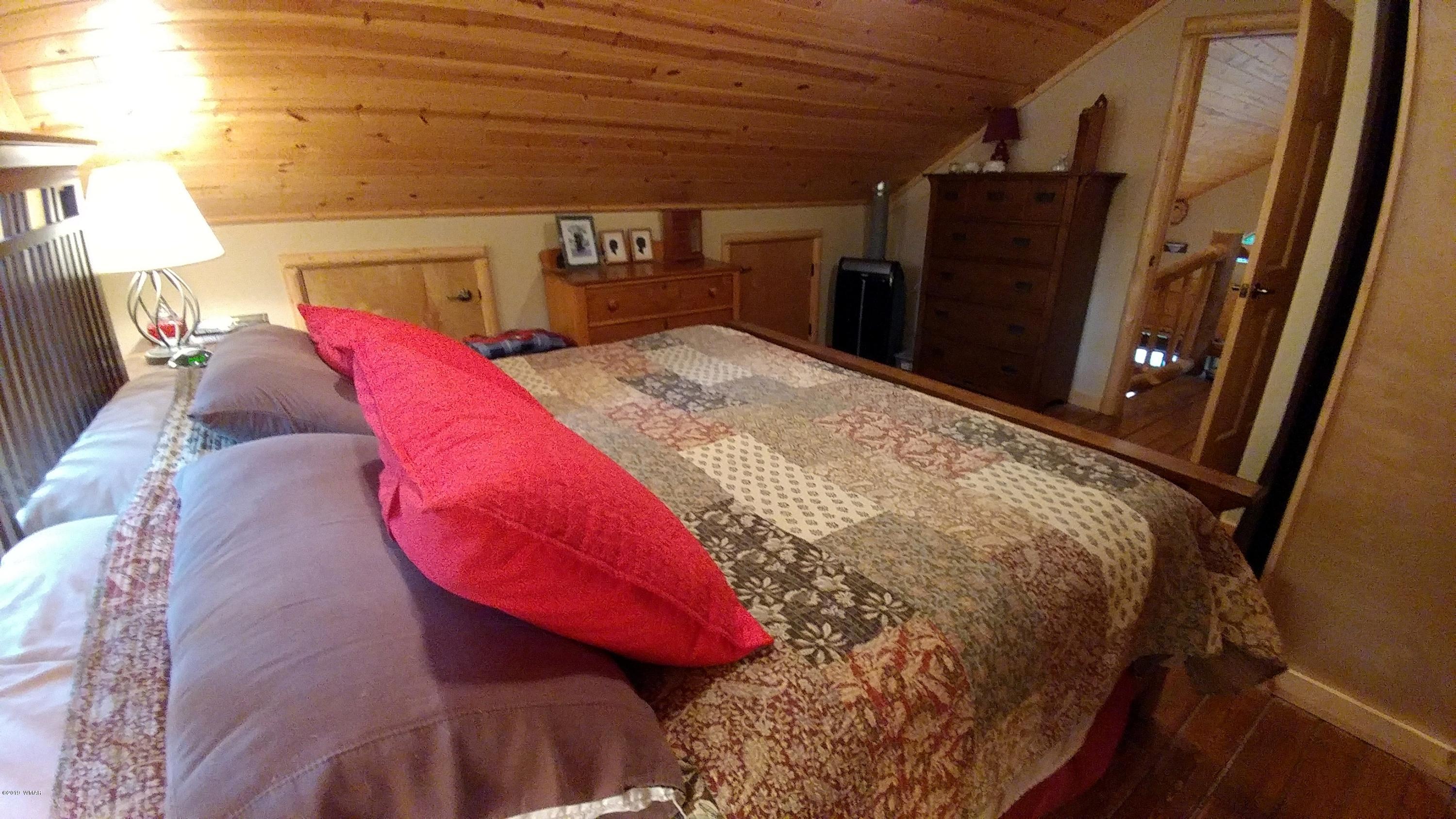 2312 Overgaard Springs Loop Overgaard, AZ 85933 - Photo 20 of 54 a bed with a bed and a mirror