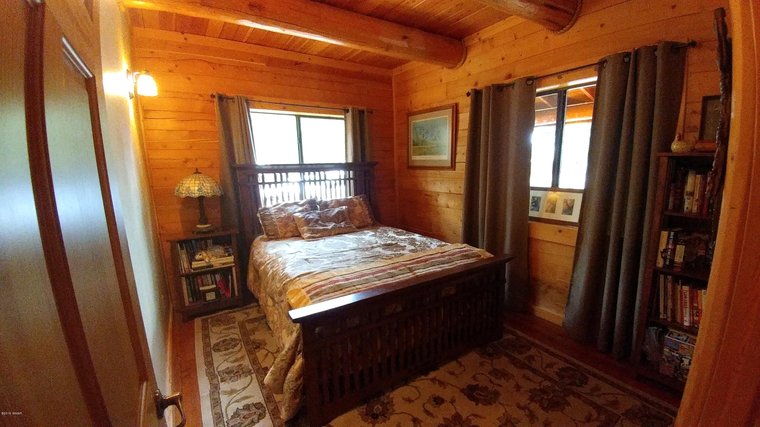 2312 Overgaard Springs Loop Overgaard, AZ 85933 - Photo 25 of 54 a bedroom with a bed and wooden floor