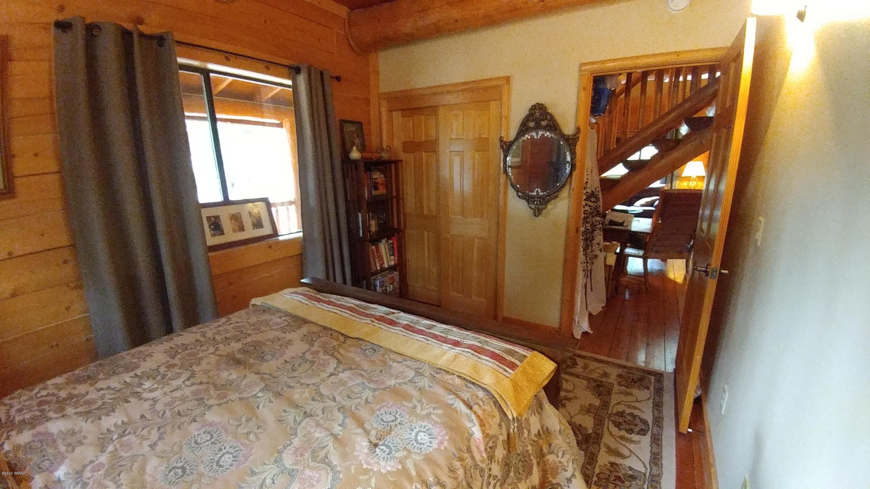2312 Overgaard Springs Loop Overgaard, AZ 85933 - Photo 26 of 54 a bedroom with a bed and a mirror