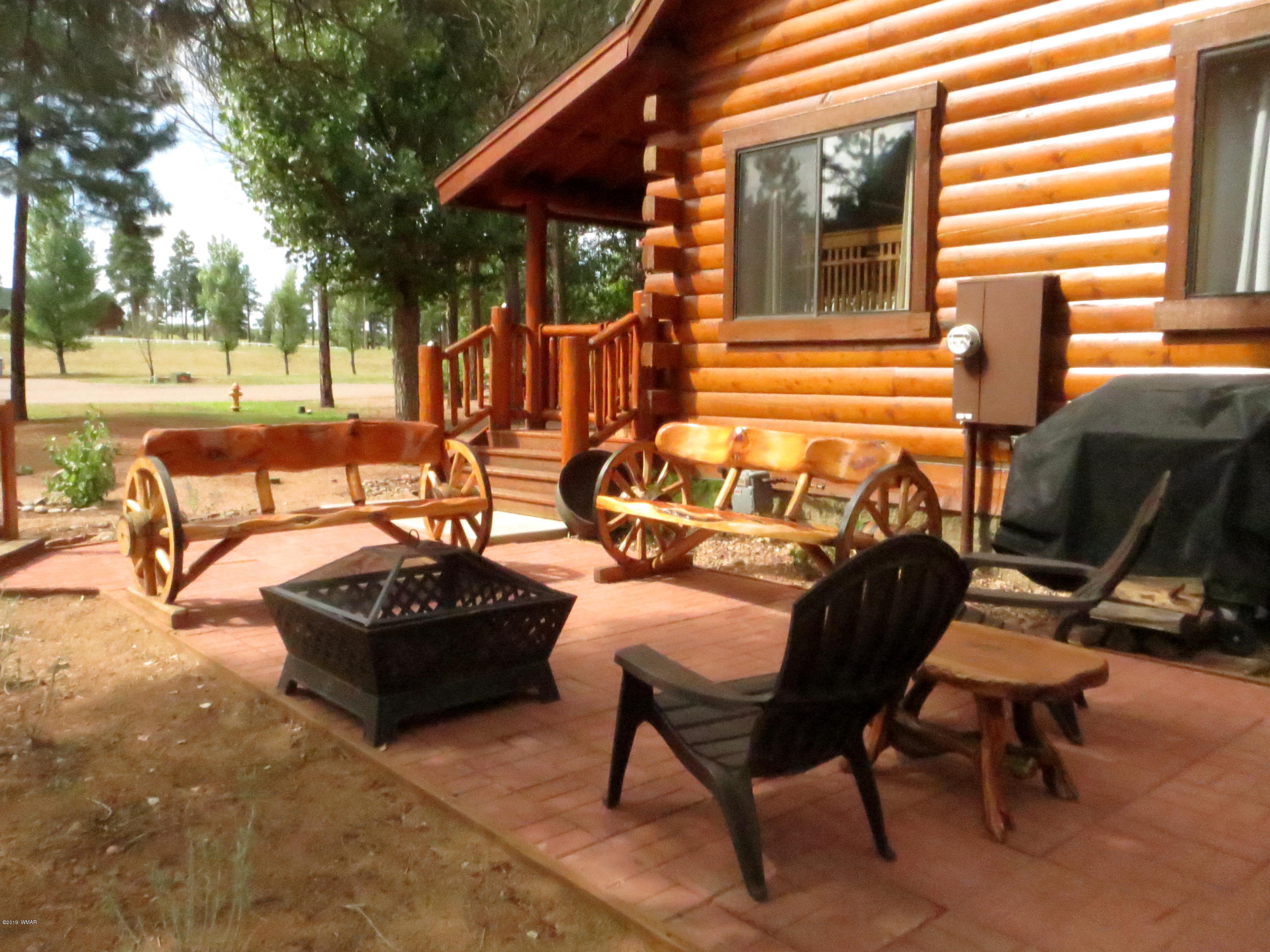 2312 Overgaard Springs Loop Overgaard, AZ 85933 - Photo 6 of 54 a view of a patio with table and chairs and floor to ceiling window