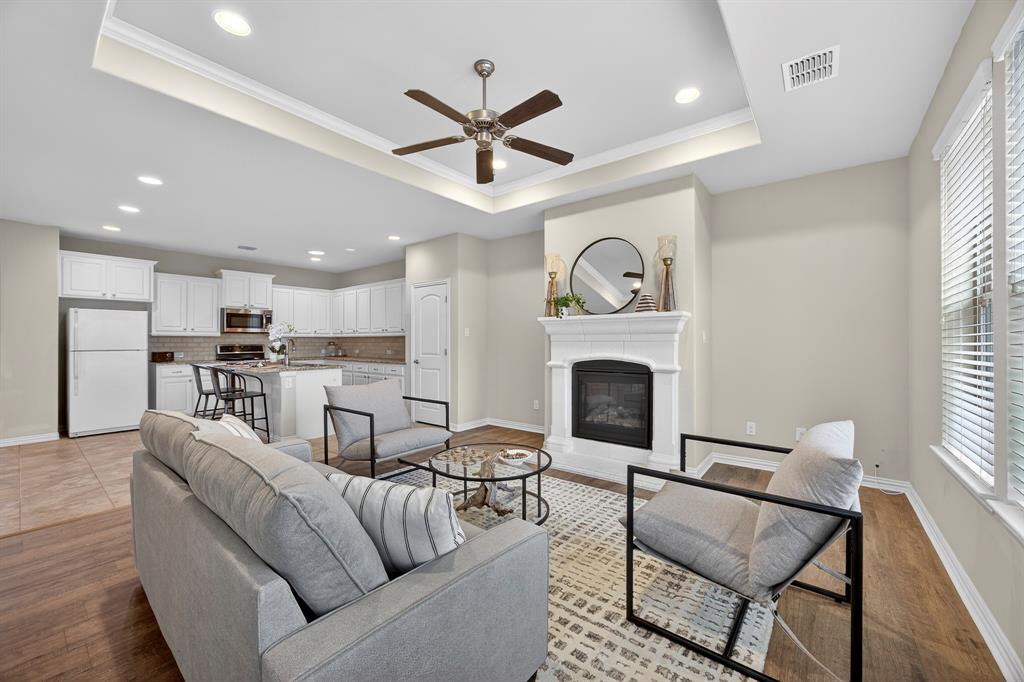 1815 Ladera Way, Unit 1815 Mansfield, TX 76063 - Photo 5 of 24 a living room with furniture a fireplace and a window